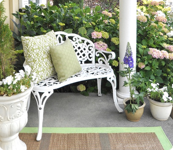 white bench green pillows hydrageas
