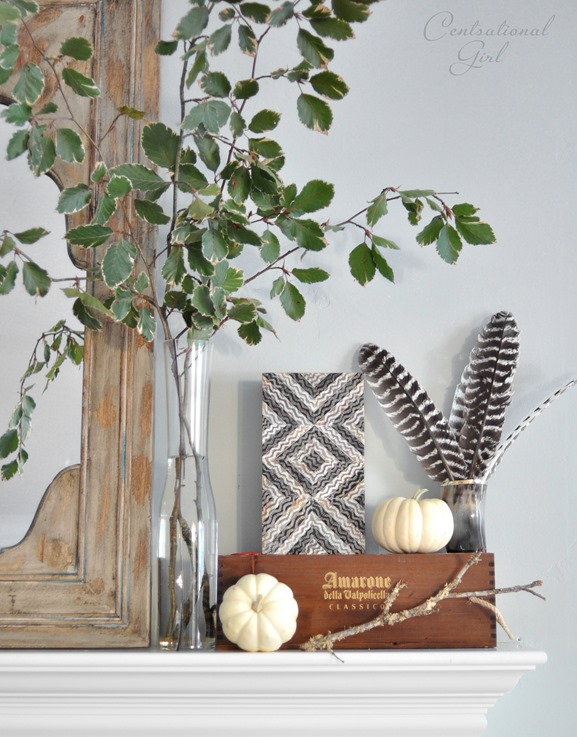 leaves pumpkins boxes on mantel